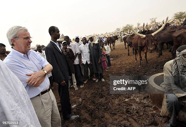 S top humanitarian official, John Holmes watches cattle during an emergency operation to distribute livestock food to the farmers on April 27, 2010...