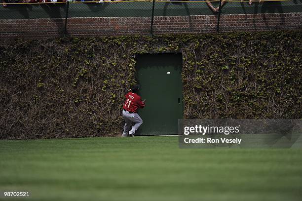 Michael Bourne of the Houston Astros cannot catch the ball hit by Koyie Hill of the Chicago Cubs on April 16, 2010 at Wrigley Field in Chicago,...