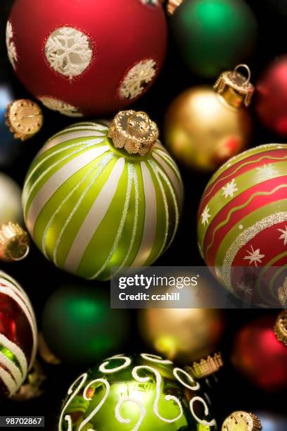 scattered holiday bulb background of varied colors and sizes - glass christmas ornament stock pictures, royalty-free photos & images