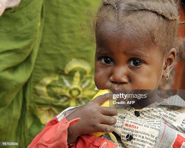 Girl eats mango on April 27, 2010 in the village of Daly, near Zinder. The UN's food agency doubled its aid on April 26, 2010 to Niger as thousands...