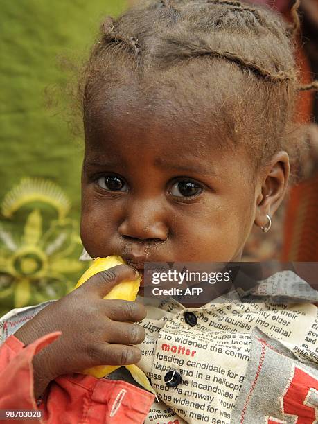 Girl eats mango on April 27, 2010 in the village of Daly, near Zinder. The UN's food agency doubled its aid on April 26, 2010 to Niger as thousands...