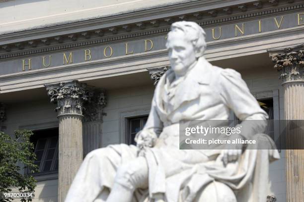 June 2018, Germany, Berlin: The statue of Alexander of Humboldt in front of the main entrance of the Humboldt University by the Unter den Linden...