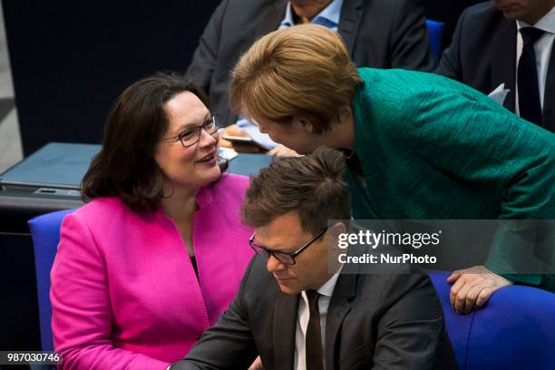 German Chancellor Angela Merkel speaks with Chairwoman of the Social Democratic Party Andrea Nahles during the 42th Plenary Session of Bundestag...
