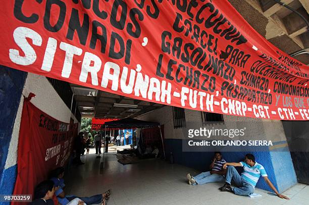 Six employees and former employees of the National Autonomous University of Honduras sit during a hunger strike in Tegucigalpa on April 27 demanding...