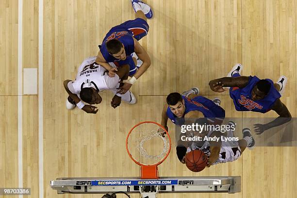 Kodi Augustus of the Mississippi State Bulldogs goes up for a shot attempt against Dan Werner of the Florida Gators during the quarterfinals of the...