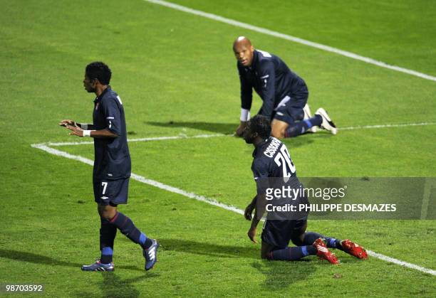 Lyon's Brazilian midfielder Michel Bastos , defender Aly Cissokho and French defender Jean-Alain Boumong react after a goal by Bayern Munich's team...
