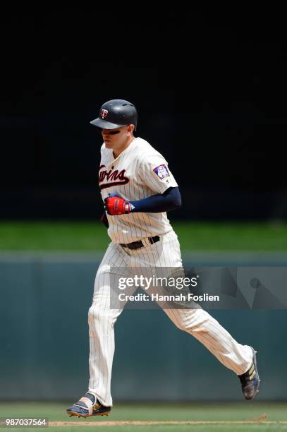 Logan Morrison of the Minnesota Twins rounds the bases after hitting a home run against the Texas Rangers during the game on June 23, 2018 at Target...