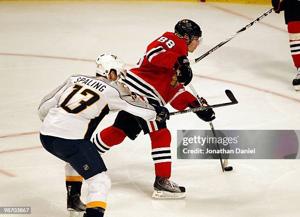 Patrick Kane of the Chicago Blackhawks shoots the puck under pressure from Nick Spaling of the Nashville Predators in Game Five of the Western...