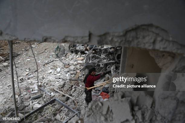 Man removes the rubble of his house which destroyed by Syrian forces' missile strikes in Al Ghouta East, in Duma, Syria, 22 February 2018. More than...