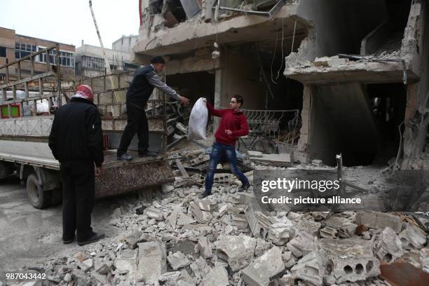 Man removes the rubble of his house which destroyed by Syrian forces' missile strikes in Al Ghouta East, in Duma, Syria, 22 February 2018. More than...