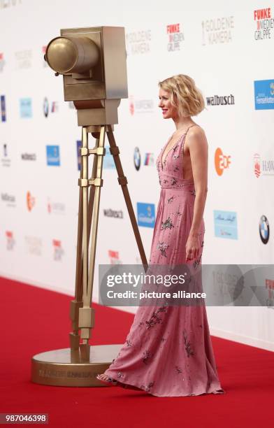 February 2018, Germany, Hamburg, Golden Camera Awards Ceremony: The actress Naomi Watts poses next to a fake golden camera. The Hollywood star will...