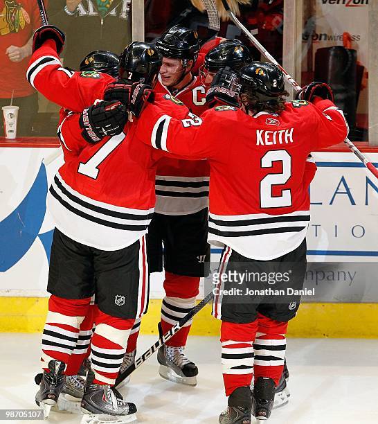 Patrick Kane, Brent Seabrook, Jonathan Toews, Patrick Sharp and Duncan Keith of the Chicago Blackhawks celebrate a goal by Kane with 13 seconds left...