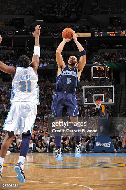 Carlos Boozer of the Utah Jazz shoots against Nene of the Denver Nuggets in Game One of the Western Conference Quarterfinals during the 2010 NBA...