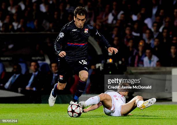 Cesar Delgado of Olympique Lyonnais is tackled by Philipp Lahm of Bayern Muenchen during the UEFA Champions League semi final second leg match...