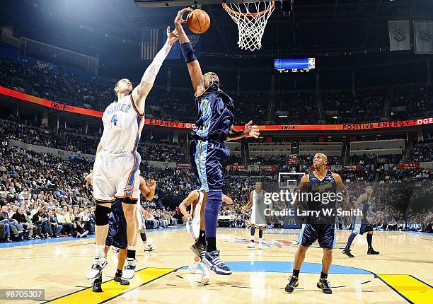 Nick Collison of the Oklahoma City Thunder and Nene of the Denver Nuggets vie for a loose ball during the game at Ford Center on April 7, 2010 in...