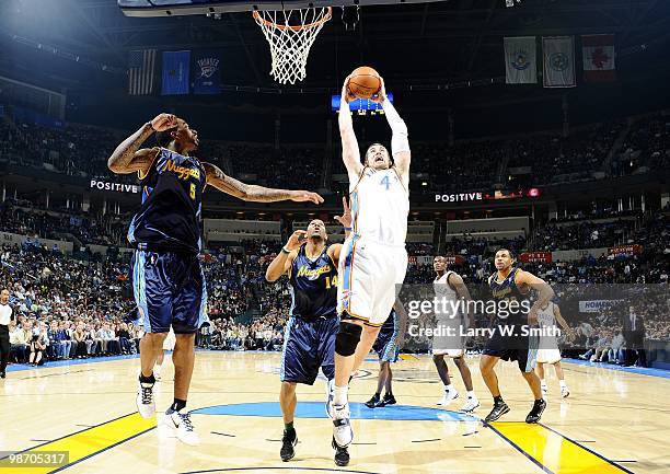 Nick Collison of the Oklahoma City Thunder rebounds the loose ball against the Denver Nuggets during the game at Ford Center on April 7, 2010 in...
