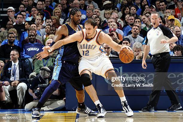 Nenad Krstic of the Oklahoma City Thunder posts up Nene of the Denver Nuggets during the game at Ford Center on April 7, 2010 in Oklahoma City,...