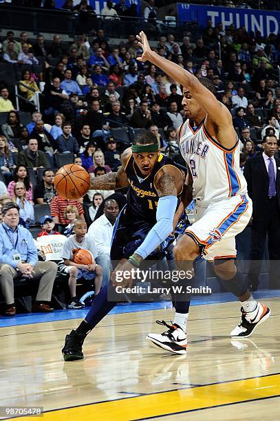 Carmelo Anthony of the Denver Nuggets dribble drives to the basket against Thabo Sefolosha of the Oklahoma City Thunder during the game at Ford...