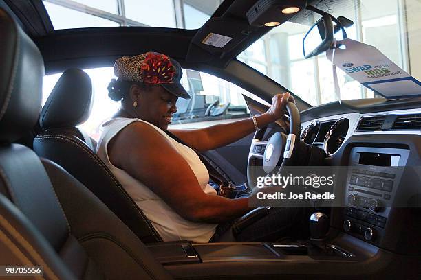 Darlene Washington checks out a Ford vehicle for sale at Metro Ford on April 27, 2010 in Miami, Florida. Ford announced today that it earned $2.08...