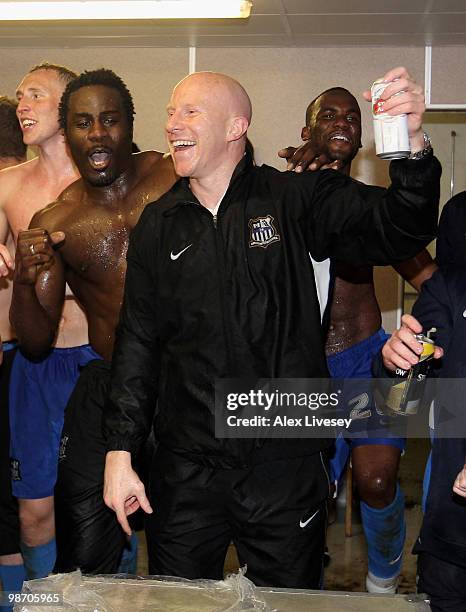 Lee Hughes and Ade Akinbiyi of Notts County celebrate in their dressing room after winning the Coca Cola League Two title after the Coca Cola League...