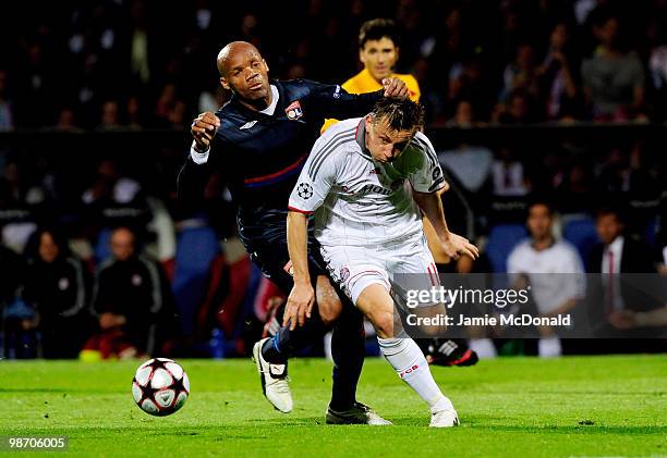 Ivica Olic of Bayern Muenchen is challenged by Jean Alain Boumsong of Olympique Lyonnais during the UEFA Champions League semi final second leg match...