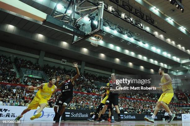 Matthew Dellavedova of Australia looks to pass the ball against Rui Hachimura of Japan during the FIBA World Cup Asian Qualifier Group B match...