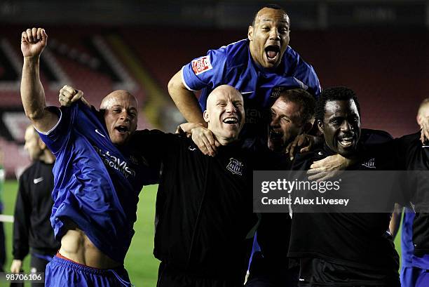 Luke Rodgers, Lee Hughes and Ade Akinbiyi of Notts County celebrate after winning the Coca Cola League Two title after the Coca Cola League Two match...