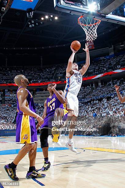 Nenad Krstic of the Oklahoma City Thunder goes up for a shot over Andrew Bynum and Derek Fisher of the Los Angeles Lakers in Game Four of the Western...