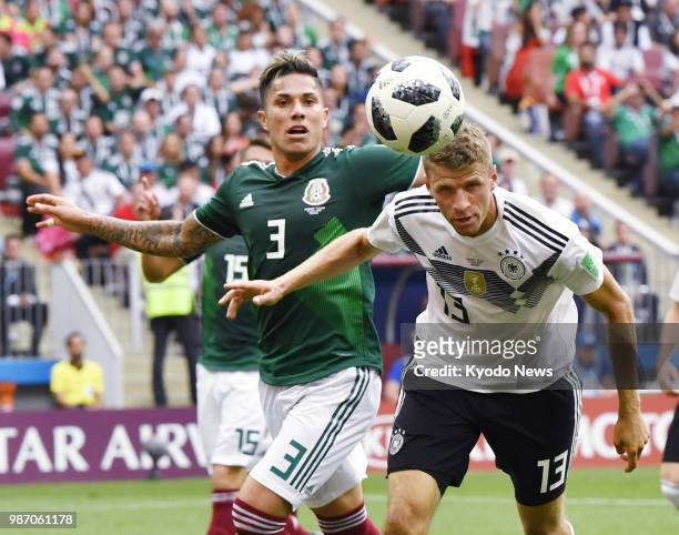 Thomas Mueller of Germany and Carlos Salcedo of Mexico vie for the ball during the first half of Mexico's 1-0 win in a World Cup Group F match at...