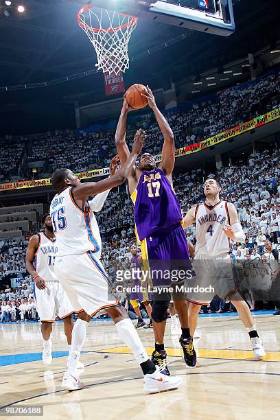 Andrew Bynum of the Los Angeles Lakers goes up for a shot over Kevin Durant and Nick Collison of the Oklahoma City Thunder in Game Four of the...