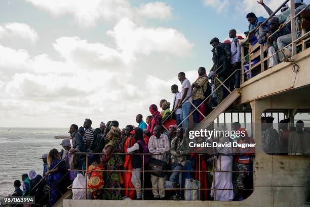 The passengers on one of the main transport arteries to cross The Gambia River is the ferry between Banjul and Barra, The Gambia. There are several...