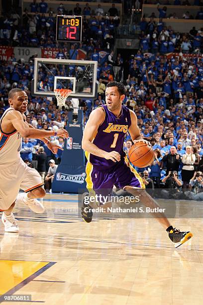 Jordan Farmar of the Los Angeles Lakers drives to the basket past Russell Westbrook of the Oklahoma City Thunder in Game Three of the Western...