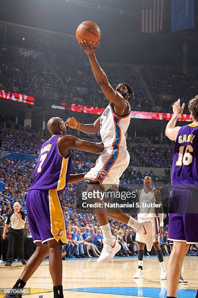 James Harden of the Oklahoma City Thunder lays the ball up over Lamar Odom of the Los Angeles Lakers in Game Three of the Western Conference...