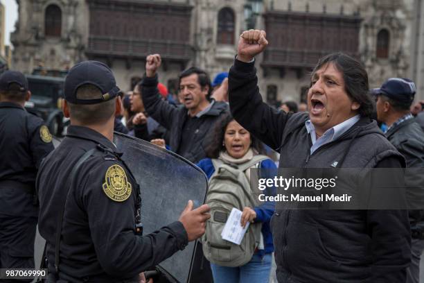 Protesters march during a protest against corruption in public institutions in front of Government Palace on June 27, 2018 in Lima, Peru.