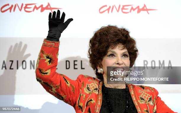 Italian actress Gina Lollobrigida waves during a photocall to present the documentary film "Gina Lollobrigida, Un simbolo italiano nel mondo" at the...