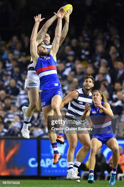 Patrick Dangerfield of the Cats marks over the top of Jackson Trengove of the Bulldogs during the round 15 AFL match between the Western Bulldogs and...