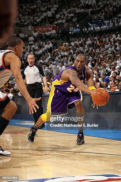 Kobe Bryant of the Los Angeles Lakers passes the ball around Thabo Sefolosha of the Oklahoma City Thunder in Game Four of the Western Conference...