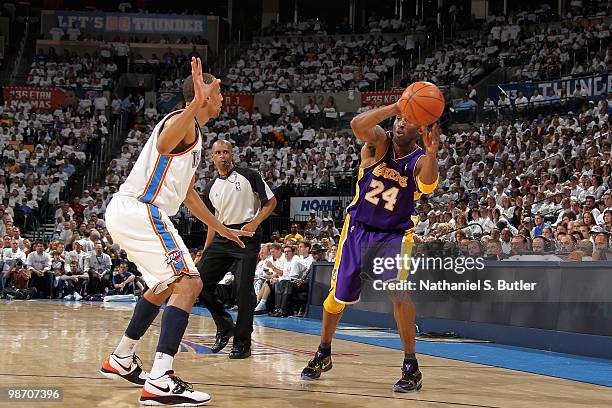 Kobe Bryant of the Los Angeles Lakers passes the ball around Thabo Sefolosha of the Oklahoma City Thunder in Game Four of the Western Conference...