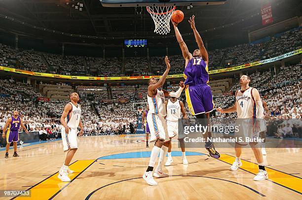 Andrew Bynum of the Los Angeles Lakers goes to the basket over Kevin Durant and Nick Collison of the Oklahoma City Thunder in Game Four of the...