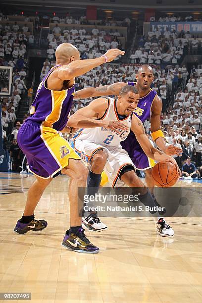 Thabo Sefolosha of the Oklahoma City Thunder tries to hold on to the ball against Derek Fisher and Kobe Bryant of the Los Angeles Lakers in Game Four...