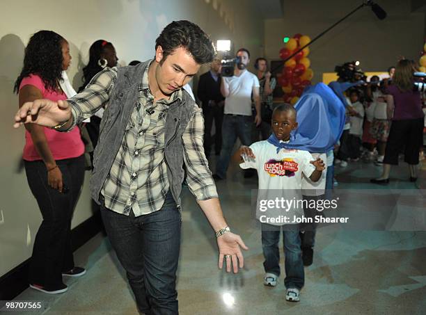 Musician Kevin Jonas of the Jonas Brothers gives students from Manhattan Place Elementary School a tour at the Natural History Museum on April 27,...