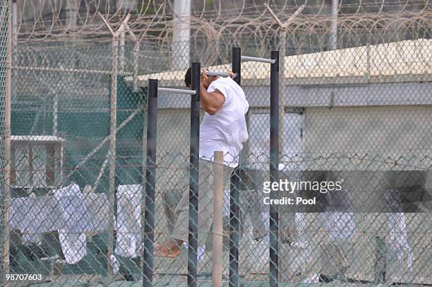 A Guantanamo detainee does pull-ups inside an exercise area at the detention facility April 27, 2010 at Guantanamo Bay U.S. Naval Base, Cuba. Today,...