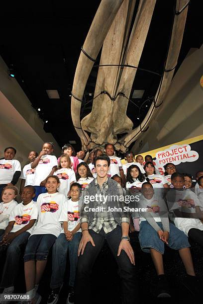 Musician Kevin Jonas of the Jonas Brothers poses with students from Manhattan Place Elementary School at the Natural History Museum on April 27, 2010...