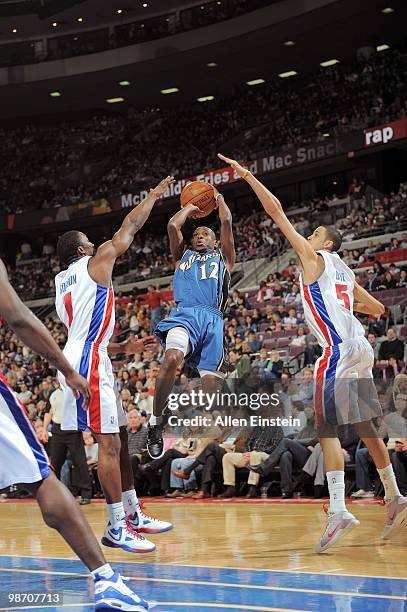 Earl Boykins of the Washington Wizards shoots between Ben Gordon and Austin Daye of the Detroit Pistons during the game on March 12, 2010 at The...