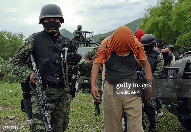 Group of people kidnapped by alleged drug-traffickers, are escorted during their freeing by members of the Mexican Army, in Sabinas Hidalgo, 99 km...