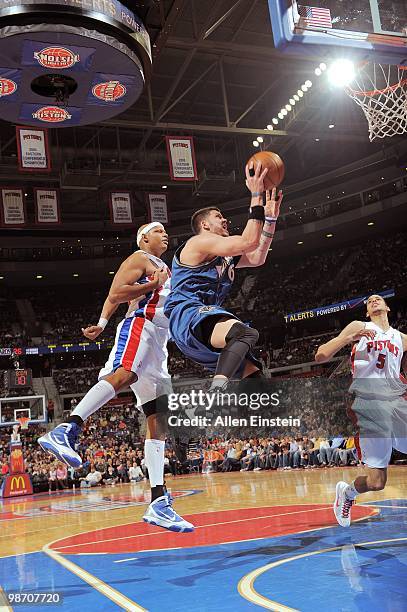 Mike Miller of the Washington Wizards shoots past Charlie Villanueva the Detroit Pistons on March 12, 2010 at The Palace of Auburn Hills in Auburn...