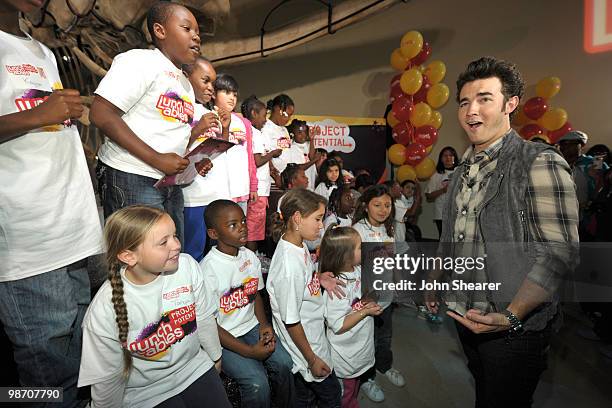 Musician Kevin Jonas of the Jonas Brothers greets students from Manhattan Place Elementary School at the Natural History Museum on April 27, 2010 in...