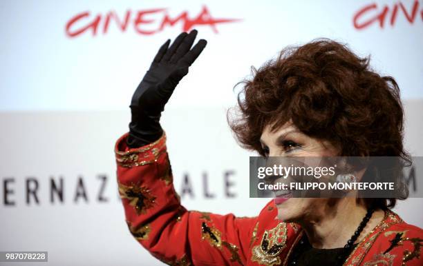 Italian actress Gina Lollobrigida waves during a photocall to present the documentary film "Gina Lollobrigida, Un simbolo italiano nel mondo" at the...