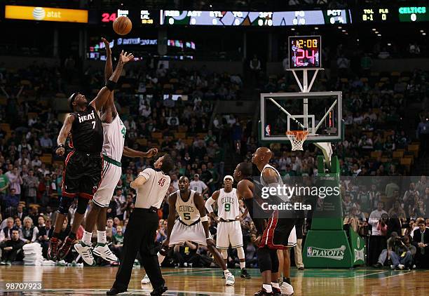 Kendrick Perkins of the Boston Celtics and Jermaine O'Neal of the Miami Heat battle for the opening tipoff during Game Five of the Eastern Conference...