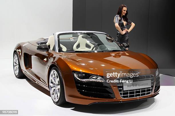 Model stands beside Audi R8 5.2 quattro car during the Beijing Auto Show on April 27, 2010 in Beijing of China. Major global automakers plan to...